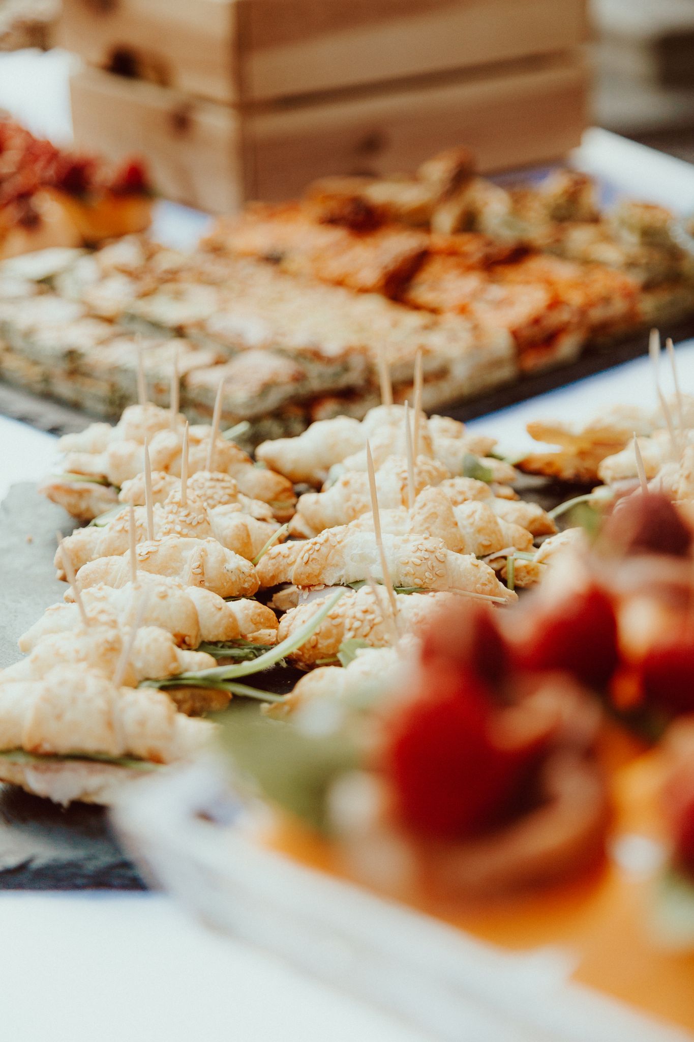 Close-up of assorted finger foods with appetizers and desserts for an event.